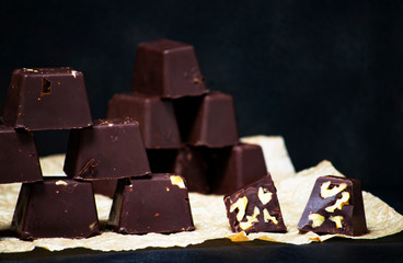 homemade chocolates with nuts on a black backgound