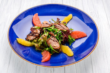 Spring salad. Wooden table background.