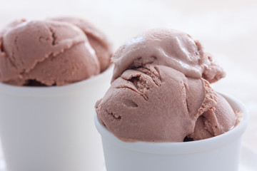 Homemade chocolate ice cream from sour cream and condensed milk in white cups, horizontal