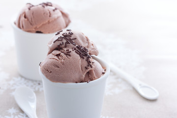 Homemade chocolate ice cream from sour cream and condensed milk in white cups, horizontal, copy space
