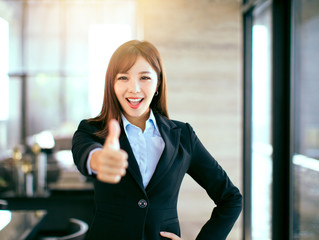 young beautiful business woman standing in office