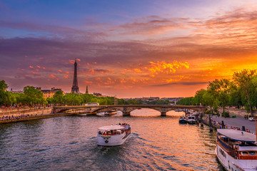 Sunset view of Eiffel tower and Seine river in Paris, France. Eiffel Tower is one of the most iconic landmarks of Paris. Cityscape of Paris - obrazy, fototapety, plakaty