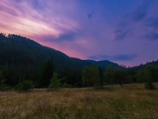 Naklejka na ściany i meble Landscape with Carpathian mountains during the sunset with amazing sunlight