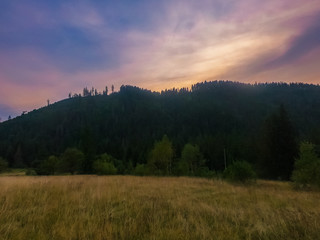 Naklejka na ściany i meble Landscape with Carpathian mountains during the sunset with amazing sunlight