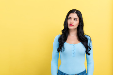 Portrait of a young woman on a yellow background