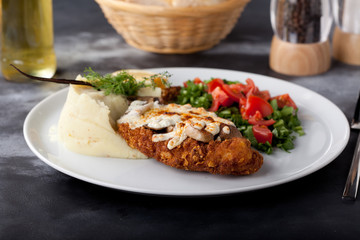 fried chicken breast with mashed potato and salad
