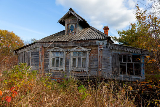 Old wooden destroyed house in countryside.