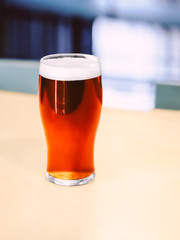 Glass of beer Close-up photo Pint of beer is standing on the bar counter