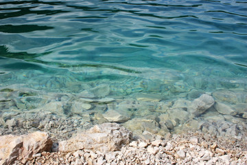 White stones and turquoise water in the lake