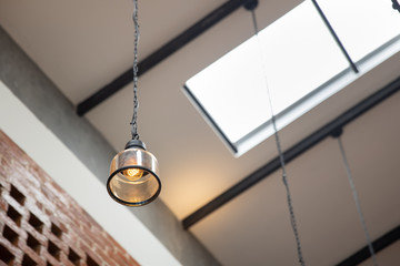Hanging vintage ceiling yellow lamp interior at day light.