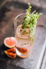 Sweet cocktail with figs liqueur and thyme. Selective focus. Shallow depth of field.