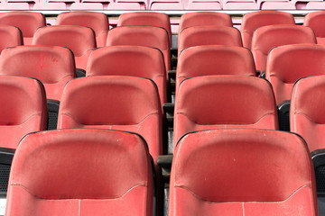 Front view of empty plastic seats in a stadium for football teams