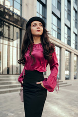 Obraz premium beautiful brunette stylish woman walking around the city.