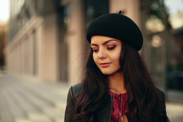 beautiful brunette woman dressed in retro style walking around the city. copy space