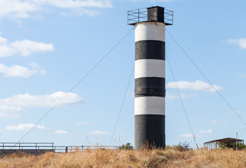 Fototapeta na wymiar Striped navigational tower, Crimea