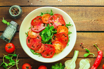 healthy salad tomatoes (vegetables, onions, greens, lettuce, sunflowers, microgreens and more) menu concept. food background. copy space. Top view