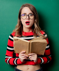 Woman in striped sweater and glasses with book