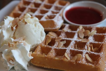 close-up strawberry waffle with almond slices on top