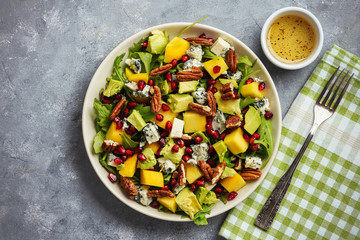 Arugula salad with mango, pomegranate, avocado, pecan nuts and blue cheese.