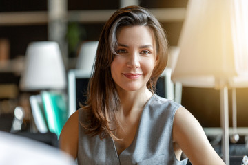portrait of a happy young woman who works in the office of the company
