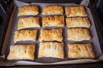 Freshly baked buns on a baking sheet in the oven. The concept of home baking, cooking. Copy space.
