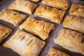Freshly baked buns on a baking sheet. The concept of home baking, cooking. Copy space.