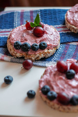  cream, blueberries and gooseberries on toasts