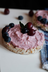  cream, blueberries and gooseberries on toasts