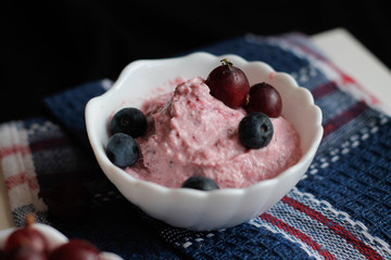 curd cream with berries in white gravy boats