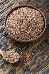 buckwheat in a plate on a wooden background