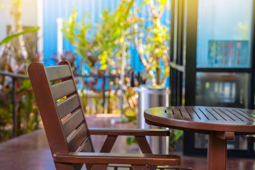 Outdoor patio chair and table. Outdoor wooden patio chair and table with sun light