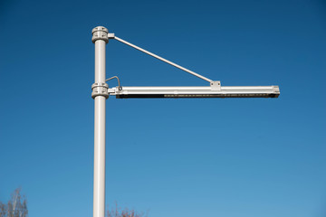 Modern street lamp in the city. Blue sky.