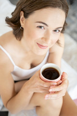 Pleased lady with a cup of coffee