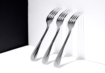 three forks on white