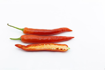 Whole chili and half sliced red chili pepper on white back ground