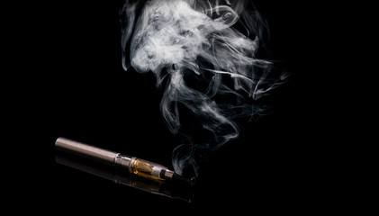 Electronic cigarettes. Smoke, closeup, on black background.