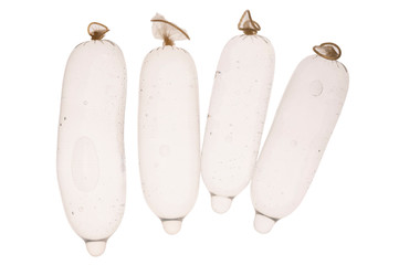 Closeup of condoms filled with water, on a white background.