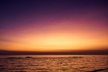 Scenic view of a summer sunset on the Ionian sea near Gallipoli, a town in the Apulian region (Italy). Landscape format.