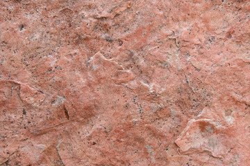 Seamless background, texture of hewn unpolished natural stone pink granite