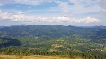 View of the Carpathian mountains under the sky with clouds