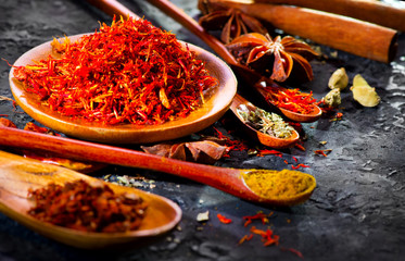 Spices. Various Indian Spices on black stone table. Spice and herbs on slate background. Assortment of Seasonings, condiments. Cooking ingredients, flavor