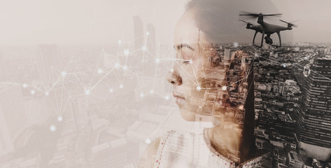 Double exposure of businesswoman and cityscape with Wireless network and Connection technology.
