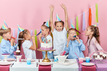 awesome children hanging out at party. isolated pink background, happy childhood, unforgettable birthday with best friends