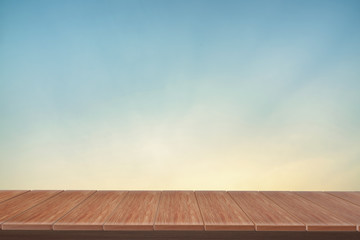 wooden table with view  blue backdrop.you can used for display products. or add your own text on space.