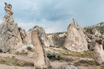 Cone shaped rock formation in valley in world famous travel destination - Cappadocia, Turkey