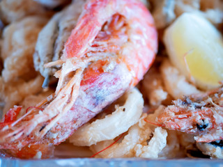 Typical Italian dish, mixed fried fresh fish with squid rings, sardines and shrimp