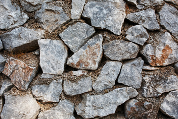 Ancient wall of gray stones, as a background, substrate.