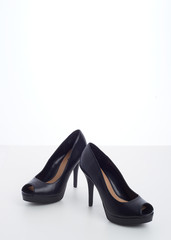 black high-heeled shoes on white