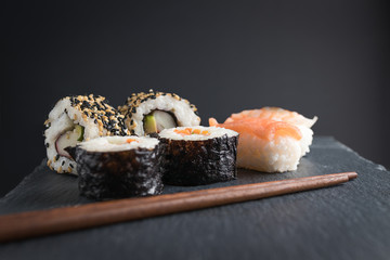 Sushi pieces on top and wooden chinese chopsticks