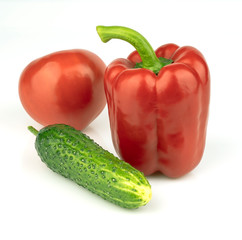 Cucumber with tomato and pepper on a white background. Vegetables on a white background. Fresh multicolored vegetables on white background